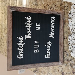 Felt canvas board/frame with a variety of letters, numbers, decorations, words.